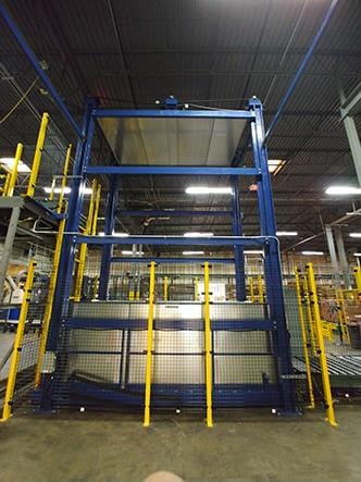 Electro-Mechanical Freightlift Transports Pallets to Conveyor Line Image