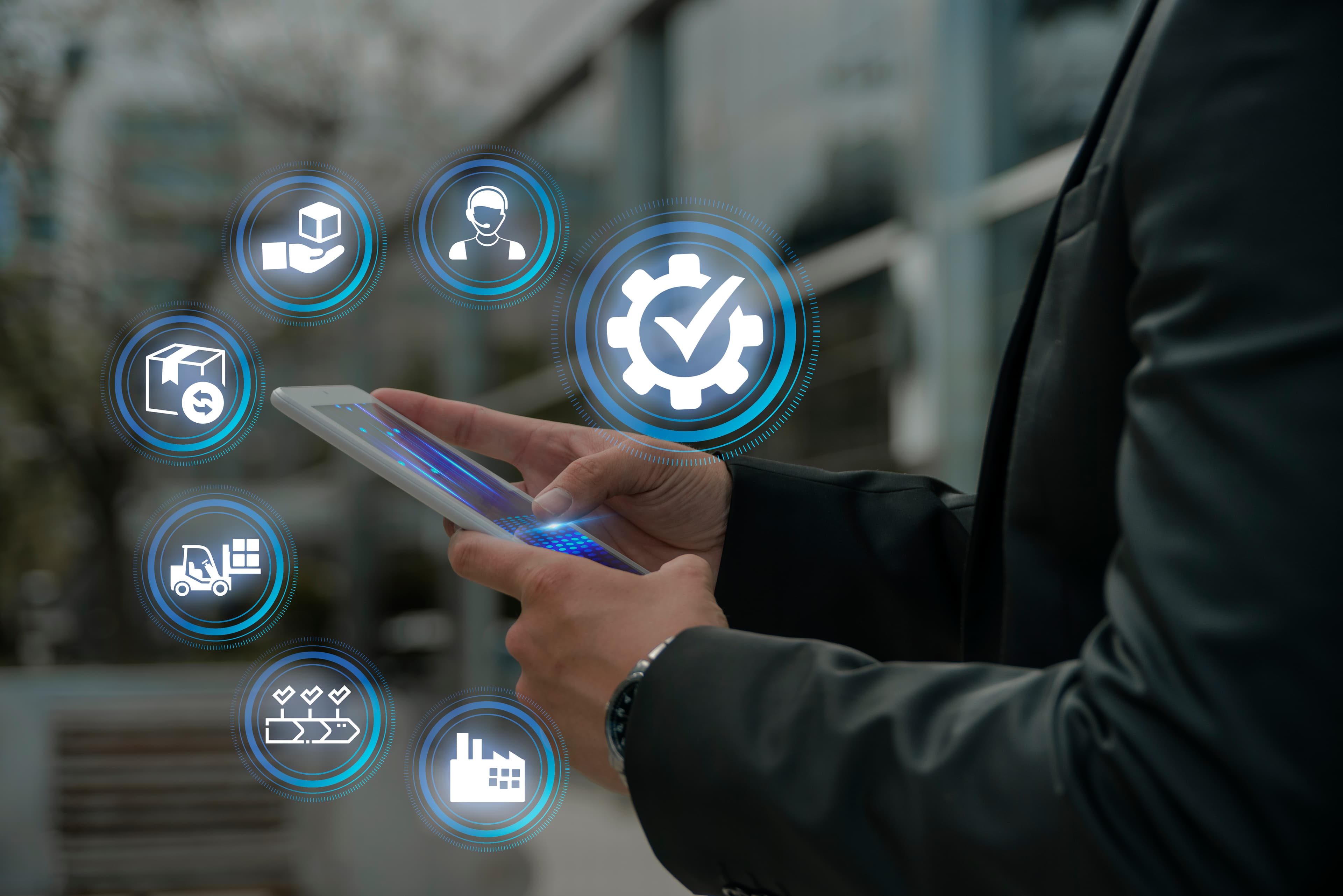 A man holding a tablet with thought bubbles and icons related to the supply chain